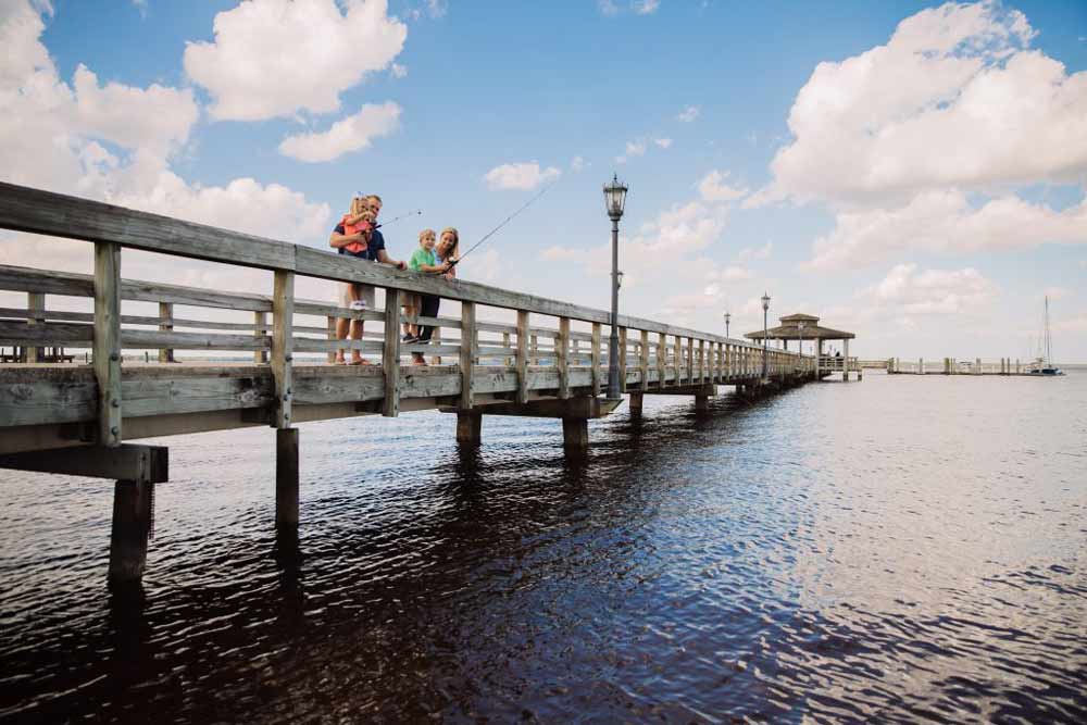 Office cleaning services in Clay County, FL—families fishing on a scenic waterfront pier, representing local communities like Orange Park and Green Cove Springs where businesses can expect office cleaning costs of $0.05–$0.20 per sq ft or $25–$50 per hour depending on office size, traffic, and cleaning needs.