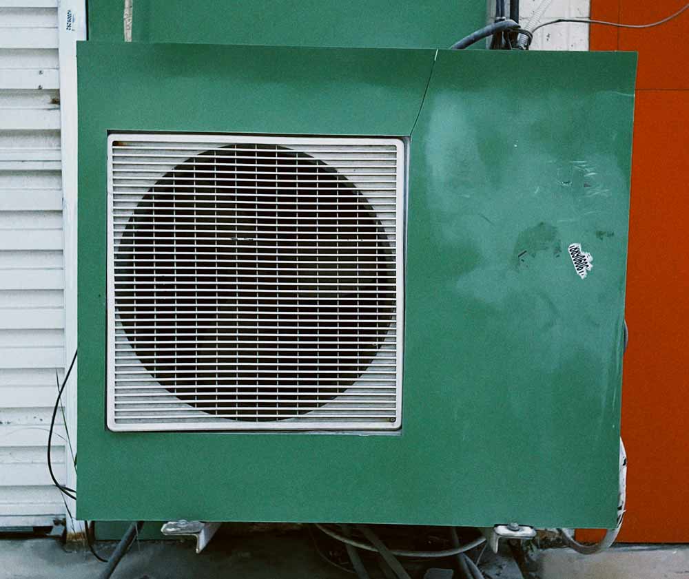 HVAC troubleshooting and maintenance—outdoor air conditioning unit with visible fan and housing, representing common system components homeowners in Jacksonville and coastal areas should inspect when diagnosing performance issues, airflow problems, or cooling failures.