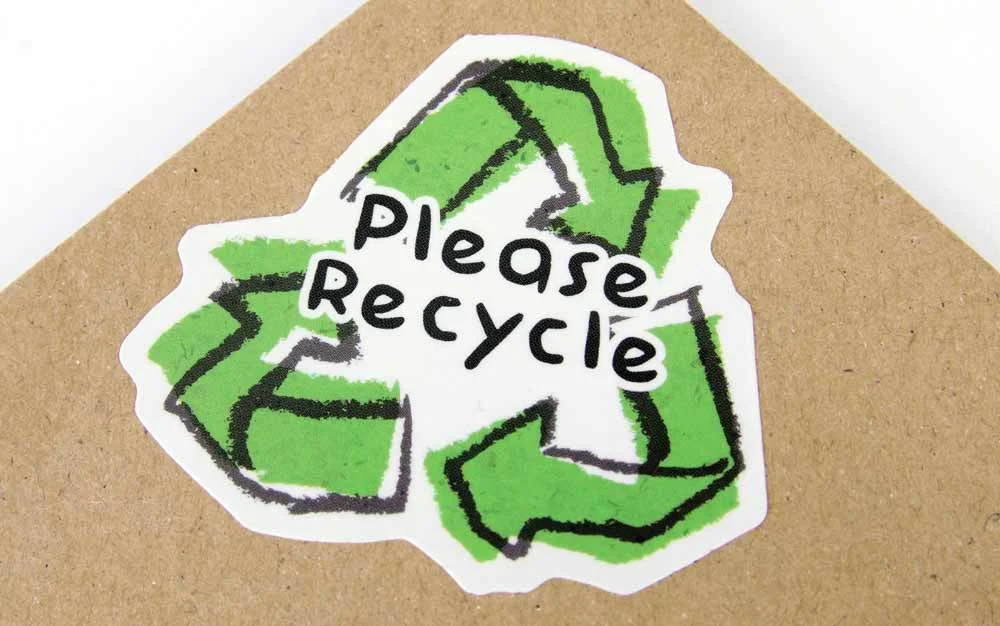 Eco-friendly packaging and sustainability awareness—recycling symbol on cardboard packaging highlighting the importance of reducing waste, supporting environmentally responsible dining choices, and promoting sustainable practices in the restaurant industry.