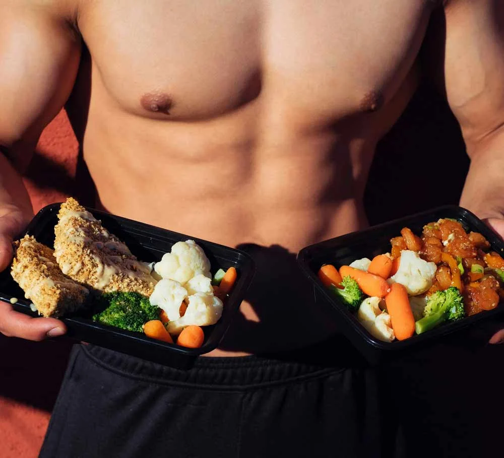Healthy meal prep for busy professionals—fit individual holding balanced meal containers with lean protein and vegetables, representing quick, nutritious eating strategies that support energy, productivity, and a healthy lifestyle for professionals in Jacksonville.